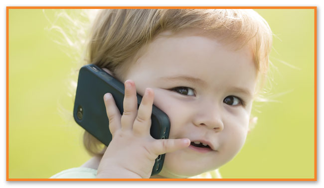 Toddler on cellphone at Montclair Pediatric Dental Care Near Verona